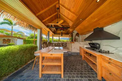 an outdoor kitchen with a wooden ceiling and a stove at kamala 1000 sqm new luxury 4 bedroom holiday pool villa extra large space amazing sunset in Kamala Beach