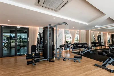 a gym with treadmills and cardio equipment in a building at Lovely studio 5 stars Hotel La Vita in Phuket Town