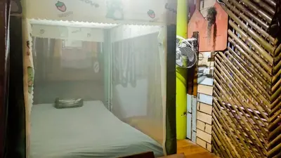 a room with a bed inside of a tent at Nu Bamboo Backpacker in Phuket