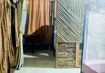 a room with curtains and a doorway with a wooden crate at Nu Bamboo Backpacker in Phuket