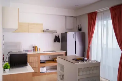 a kitchen with a refrigerator and a desk with a sink at 4BR Pool Villa Sukhum in Phuket Town in Changwat Phuket