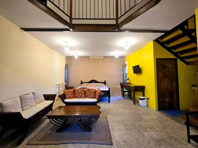 a living room with a couch and a table at Baibon3 Homestay Thalang Phuket in Ban Na Nai