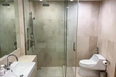 a bathroom with a shower and a toilet and a sink at Baan Mai Khao Condo Phuket for rent in Phuket
