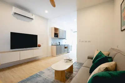 a living room with a couch and a tv at Winks Beach Patong Phuket in Patong Beach
