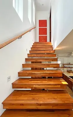 a staircase in a house with wooden floors at At the Beach New 6-9 person Pool Villa Ao Yon Phuket in Ko Thanan