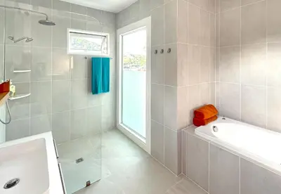 a bathroom with a tub and a shower and a sink at At the Beach New 6-9 person Pool Villa Ao Yon Phuket in Ko Thanan