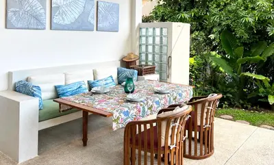 a patio table with a table cloth on it at At the Beach New 6-9 person Pool Villa Ao Yon Phuket in Ko Thanan