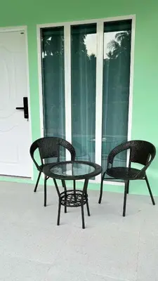 two chairs and a glass table on a patio at The Saii in Ko Yao Yai