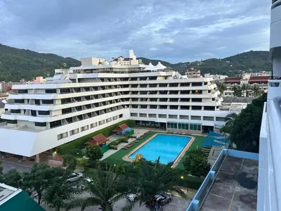 a large building with a swimming pool and a resort at Patong tower mountain view m705 in Patong Beach