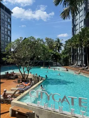 a large swimming pool with people in the water at C161 1Km to beach New City gate in Kamala Beach