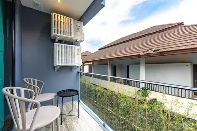 a balcony with two chairs and a heater at C161 1Km to beach New City gate in Kamala Beach