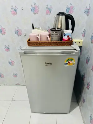 a white refrigerator with a basket on top of it at Navy Guesthouse in Ban Laem Sai