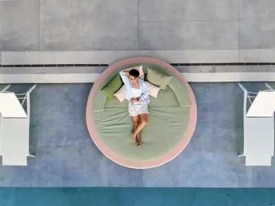 a man is laying in a bed in a circle at Veranda Resort Phuket, Autograph Collection in Panwa Beach