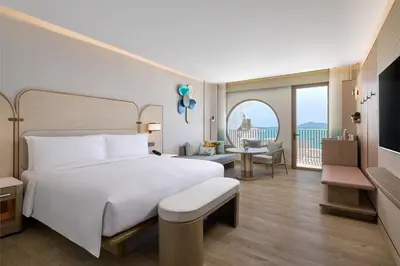 a bedroom with a large white bed and a balcony at Veranda Resort Phuket, Autograph Collection in Panwa Beach
