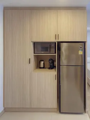a kitchen with a stainless steel refrigerator and a microwave at 2 BD Skypark Condo in Laguna Phuket