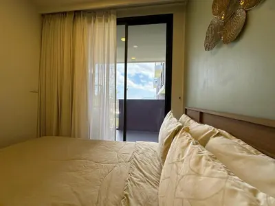 a bedroom with a bed and a large window at 2 BD Laguna Skypark Condo in Phuket