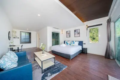 a bedroom with a bed and a living room at Patong Cliff Villa Phuket 12 bedroom in Patong Beach