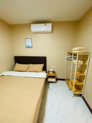 a small bedroom with a bed and a book shelf at Coral Retreat Koh Yao Yai in Ko Thanan