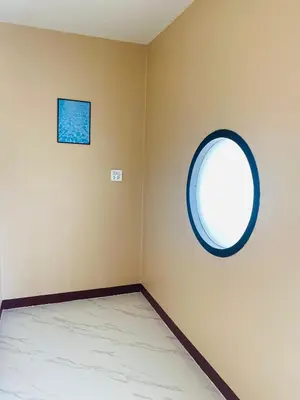 a room with a round window on the wall at Coral Retreat Koh Yao Yai in Ko Thanan