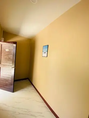 a corner of a room with a refrigerator at Coral Retreat Koh Yao Yai in Ko Thanan