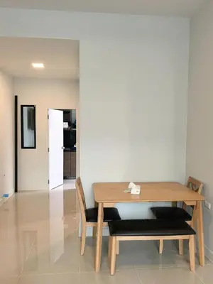 a dining room with a table and chairs and a refrigerator at 150 square meters 3BR with parking townhouse near golf course, UWC school, Nayang Beach, airport in Ban Muang Mai (1)