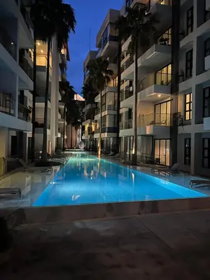 an empty swimming pool in an apartment building at night at Palmyrah Surin Beach Residence in Surin Beach