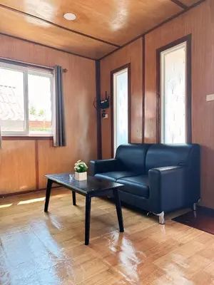 a living room with a couch and a table at Friendly house in Ko Phlong