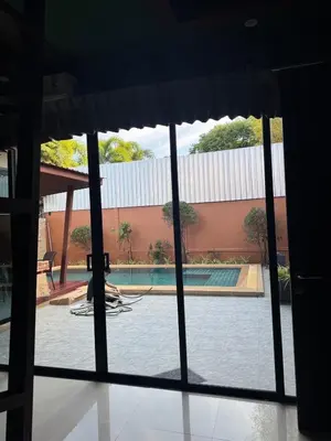 a view of a swimming pool through a window at Pool villa Phuket in Kata Beach