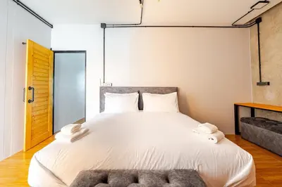 a bedroom with a large bed with two towels on it at Cactus Villa 2024 in Klong Muang Beach