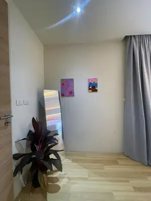 a room with a plant and paintings on the wall at Prime Location46 sqm Room, King-Size Bed in Ao Nang Beach