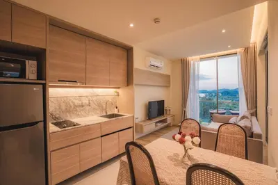 a kitchen with a table and chairs and a kitchen with a view at Luxury sea view apartments in Ao Nang Beach