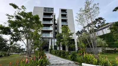 an apartment building with a garden in front of it at Patong Sea View pool view condo in Patong Beach