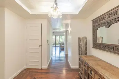 a hallway of a home with a mirror on the wall at 3BR Casa Blanc - Beachfront Home in Laguna & Layan Chom Tawan and Maan Tawan Residences in Phuket