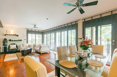 a living room with a glass table and chairs at 3BR Casa Blanc - Beachfront Home in Laguna & Layan Chom Tawan and Maan Tawan Residences in Phuket