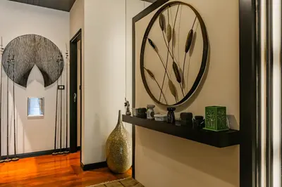 a hallway with a large clock on the wall at 3BR Casa Blanc - Beachfront Home in Laguna & Layan Chom Tawan and Maan Tawan Residences in Phuket