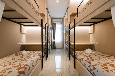 a room with three bunk beds and a hallway at Noppharat Krabi Resort in Ao Nang Beach