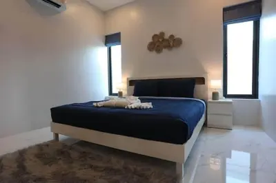 a bedroom with a blue bed and a window at V150 5-Star Villa Perfect for Relaxation &Comfort in Rawai Beach