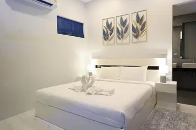 a bedroom with a white bed with a towel on it at V150 5-Star Villa Perfect for Relaxation &Comfort in Rawai Beach