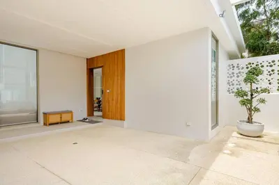 an empty living room with a potted plant on the floor at Lux Pride Villa 3 bedroom Phuket Bang-Tao beach in Ban Phak Chit
