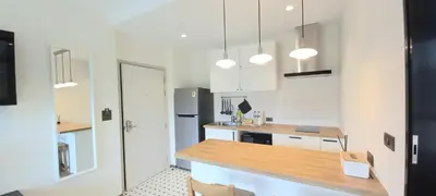 a kitchen with white cabinets and a wooden counter top at JU1 NEW Halo Nayang Руб ВАТСАП669З582I976 in Nai Yang Beach
