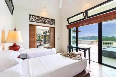 a bedroom with two beds and a view of the ocean at 10 - Panoramic View on Ao Yon Beach in Ko Thanan