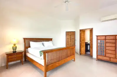 a bedroom with a large bed and a dresser and a bed sidx sidx sidx at 10 - Panoramic View on Ao Yon Beach in Ko Thanan