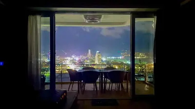 a table and chairs on a balcony with a view of the city at Sawansa 34B 475m2 Luxury Sea view pool near beach in Patong Beach