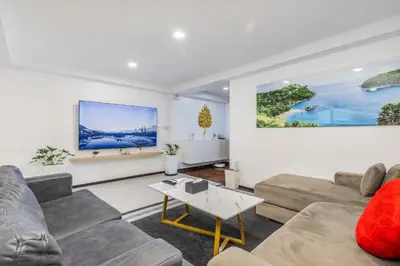 a living room with a couch and a table at Sawansa 20 3BR 300m2 Modern Seaview house near Beach in Patong Beach