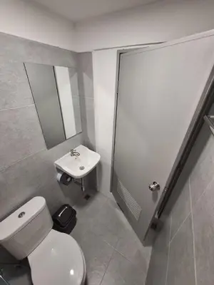 a bathroom with a toilet and a sink at Phuket Hostel at Rawai in Phuket Town
