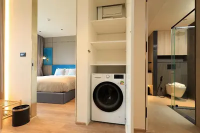 a washing machine in a room with a bedroom at New 1bdr apartment BangTao Beach C410 in Laguna Phuket