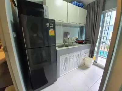 a kitchen with a black refrigerator and a sink at Dcondo Kathu Poolview by LaChambre Phuket in Phuket Town
