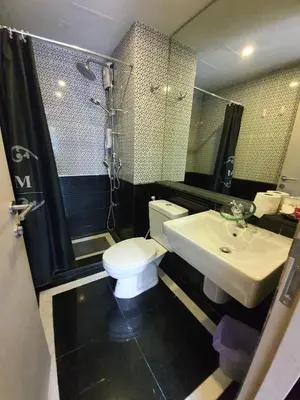 a bathroom with a toilet and a sink and a shower at Dcondo Creek Poolview by Lachambre Phuket in Phuket Town
