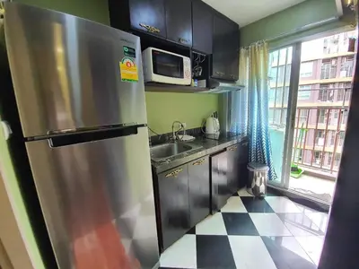 a kitchen with a stainless steel refrigerator and a microwave at Dcondo Creek Poolview by Lachambre Phuket in Phuket Town