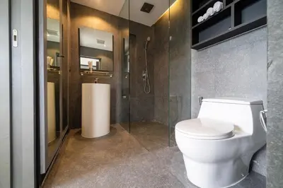 a bathroom with a white toilet and a shower at Apartment 1 - bedroom Kamala in Kamala Beach